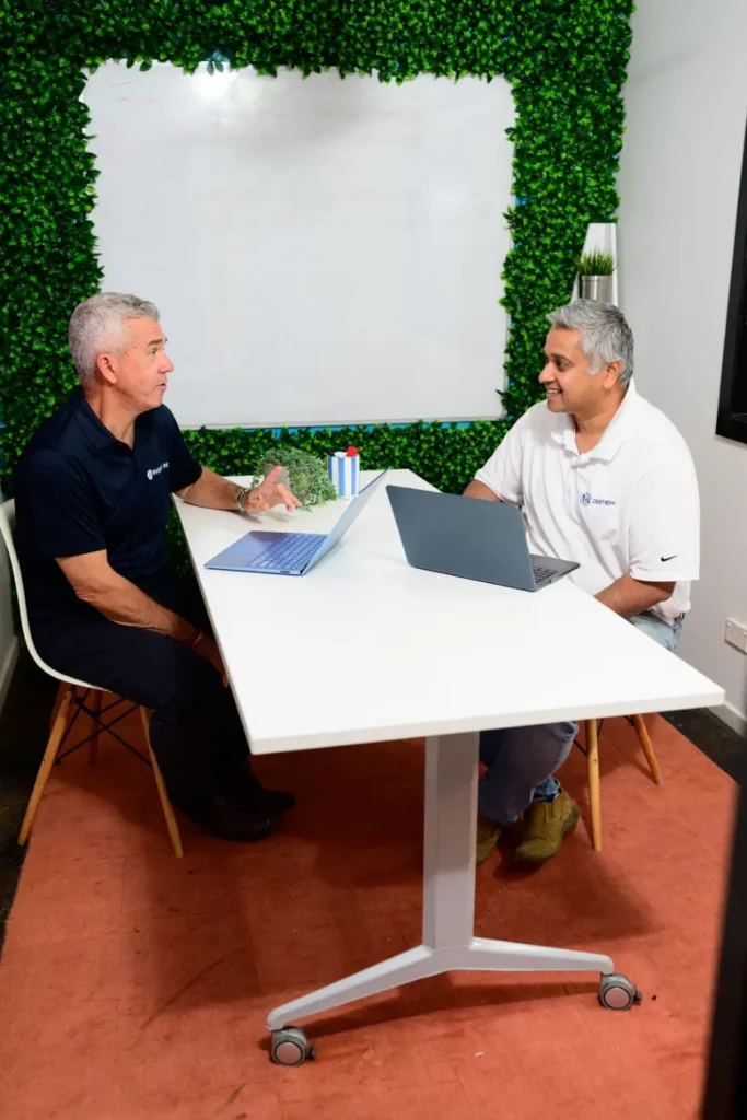 Jim Thomas from Digitek IT and a client at a white meeting table