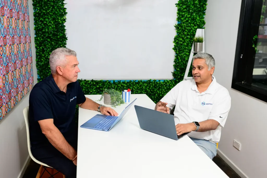 Jim Thomas from Digitek IT talking with a business owner across a meeting table