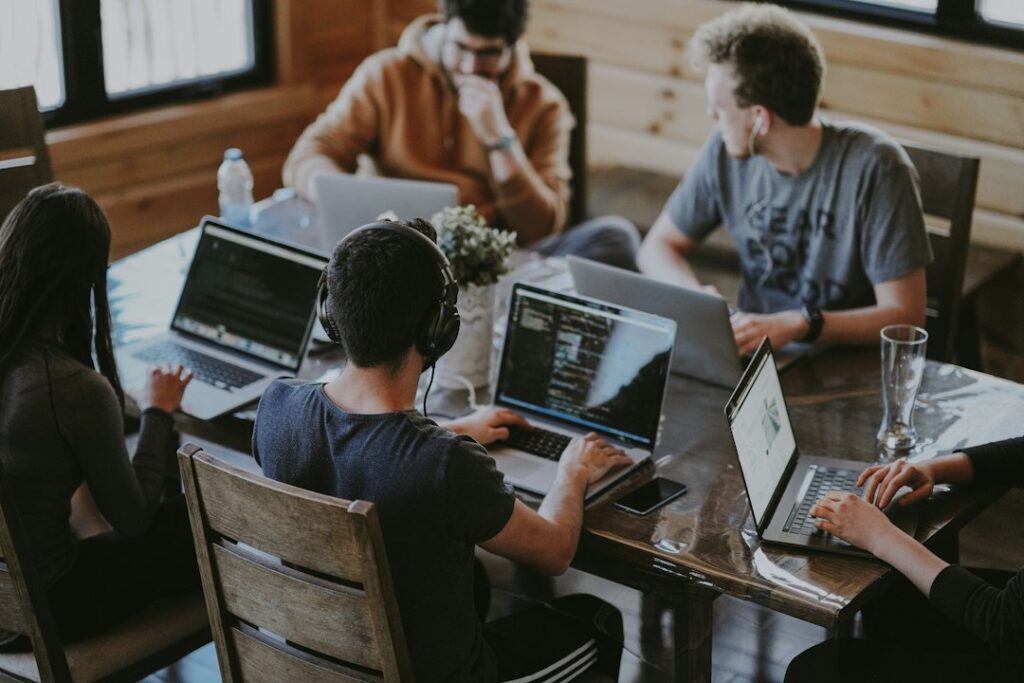 Small business team working together on laptops