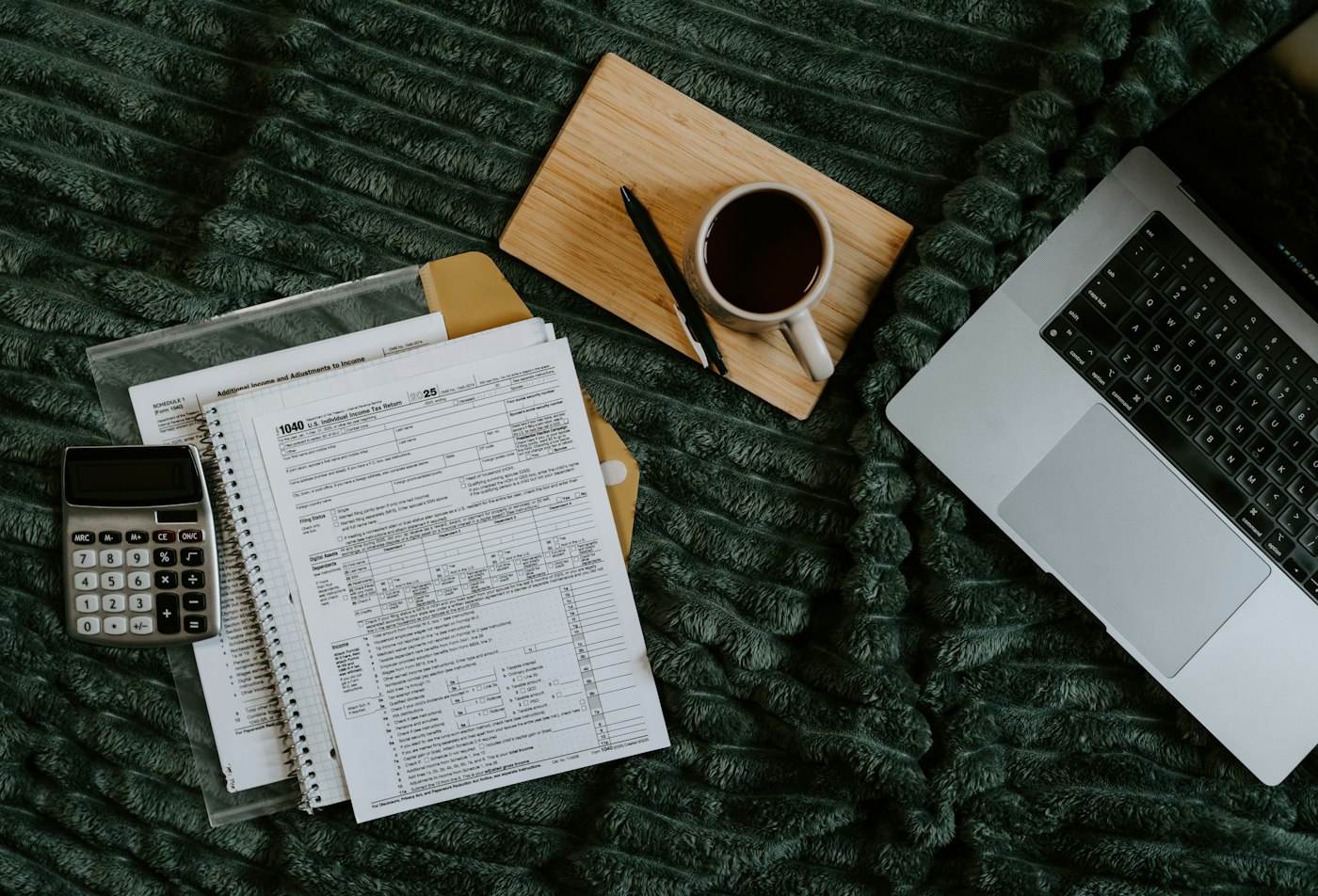 Laptop, papers and a calculator while working from home