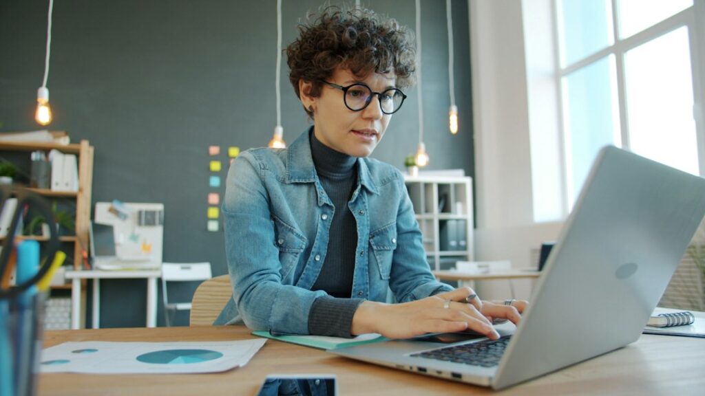Woman working on a laptop at an office desk